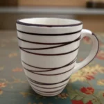 Cosmic Lines ceramic coffee mug with a modern celestial pattern