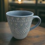 Striscia Oceano ceramic coffee mug with blue ocean-inspired stripes