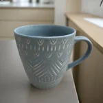 Striscia Oceano ceramic coffee mug with blue ocean-inspired stripes