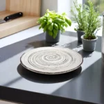 Handmade spiral ceramic plate with an artistic swirl design.