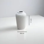Vel Bianco ceramic vase with sleek white design, perfect for floral arrangements in the living room